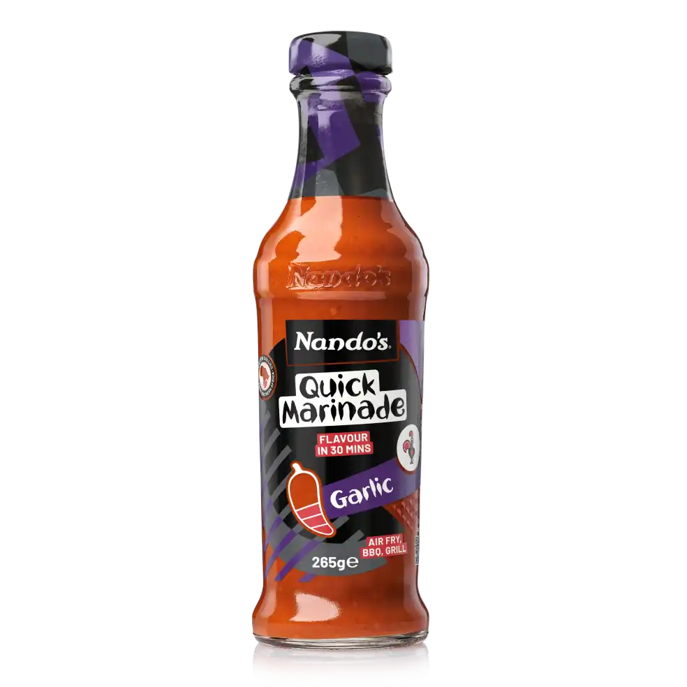 Nando's Garlic Quick Marinade bottle, 265g, featuring purple and black label design with a chili icon.